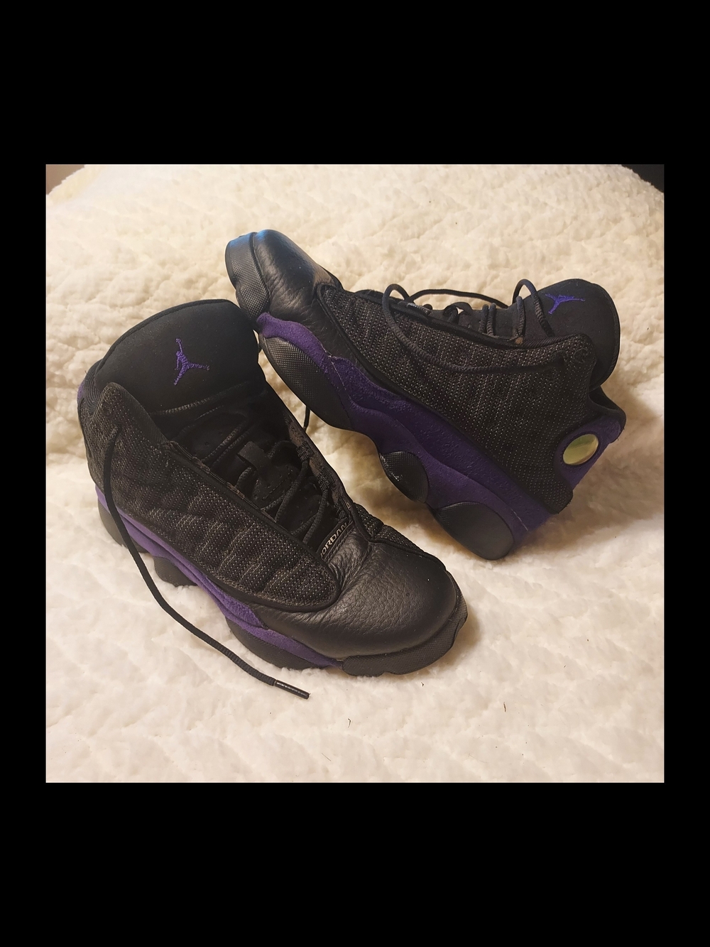 Nike Air Jordan 13 Retro "Court Purple" sneakers in a black and purple colorway.